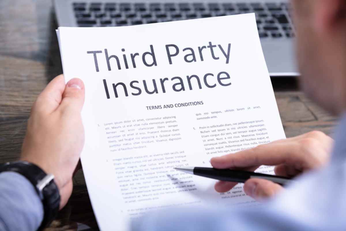 Person reading a third-party insurance policy document.