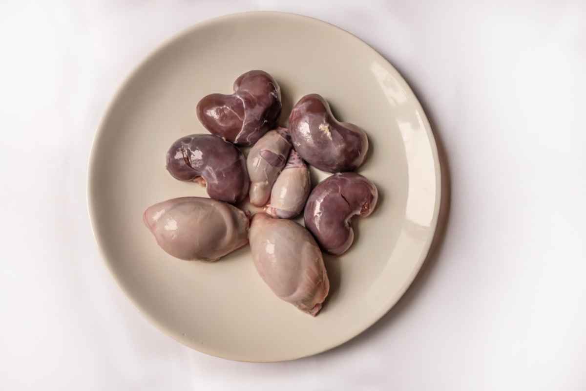 Icelandic Cuisine: Raw lamb kidneys and testicles prepared for traditional dishes Plate of raw lamb kidneys and testicles, traditional Icelandic ingredients