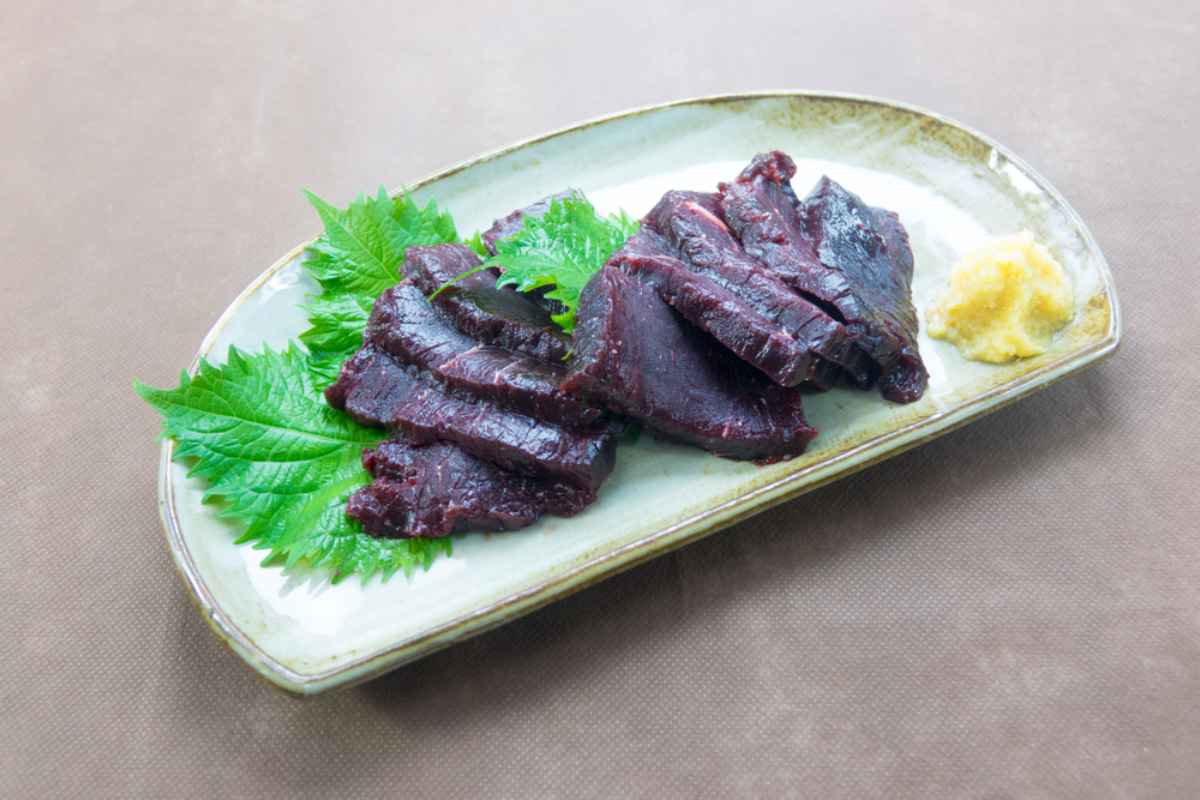 Pieces of raw whale meat slices of whale meat served along with butter