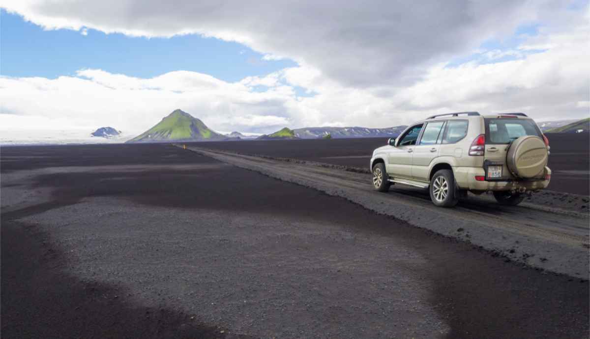 4x4 vehicle on an F-Road that's going through a Lava field