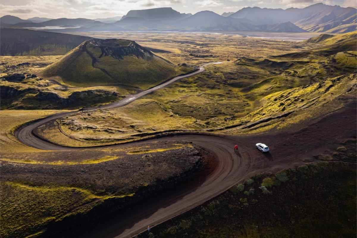 White suv driving through Landmannalaugar