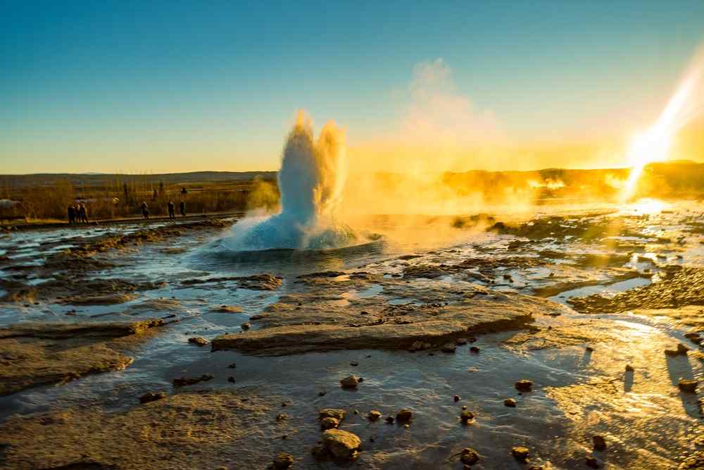 Golden Circle in Iceland Geyser erupting at sunset along Iceland’s Golden Circle route.