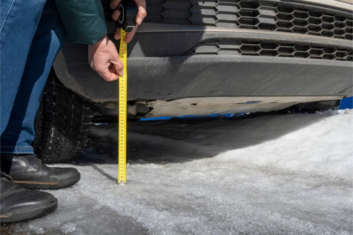 Important details when renting a car in Iceland Man checking his vehicle ground clearance