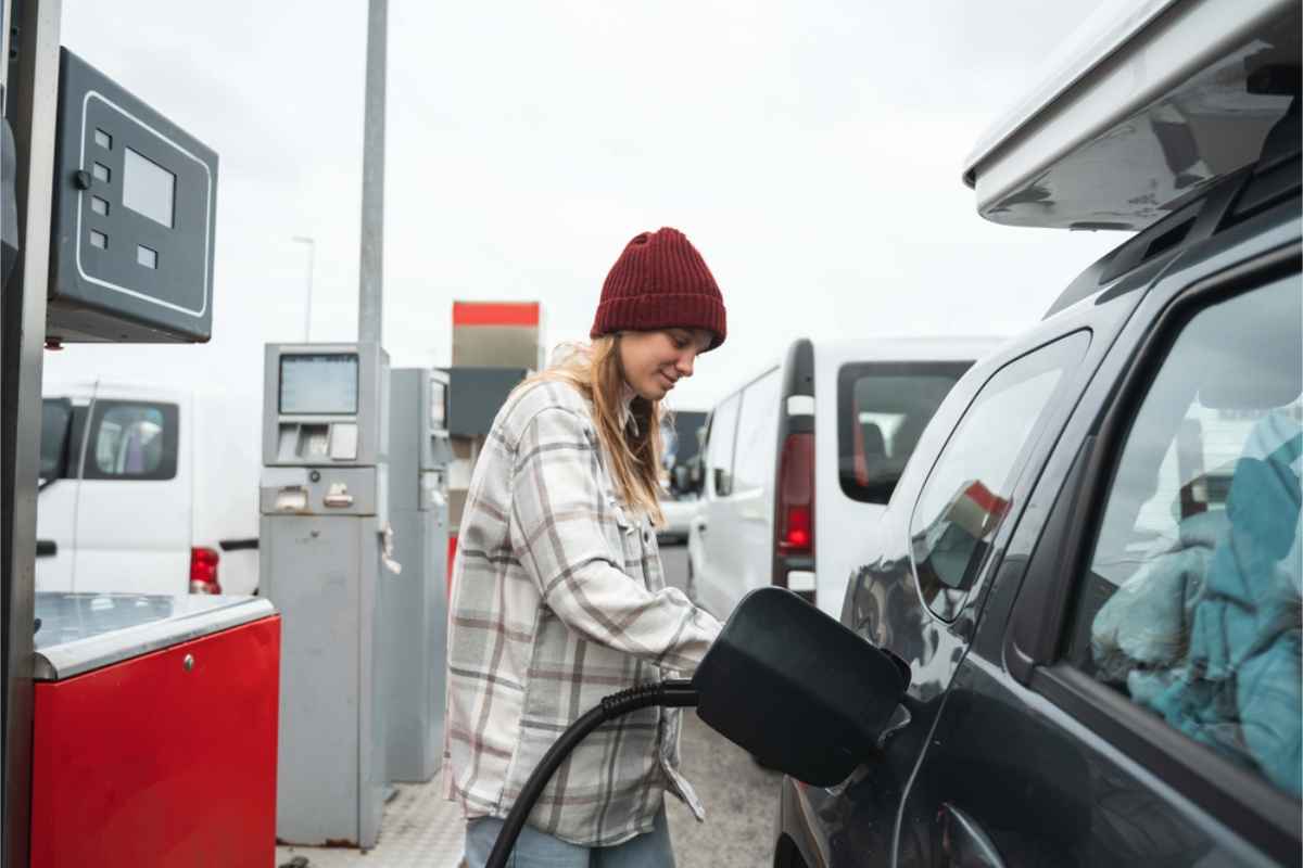 woman fueling up her car at an Icelandic gas station