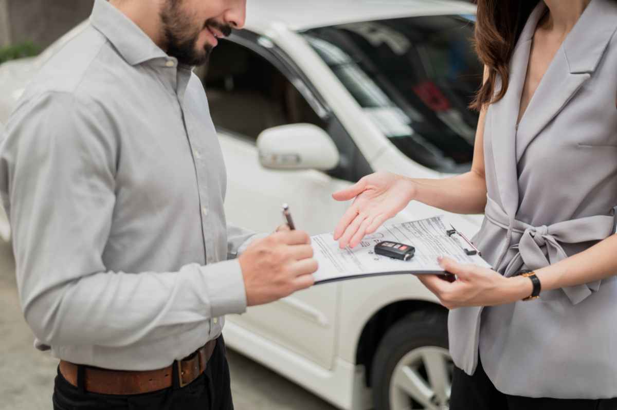 Renter returning his rental car and signing the final form
