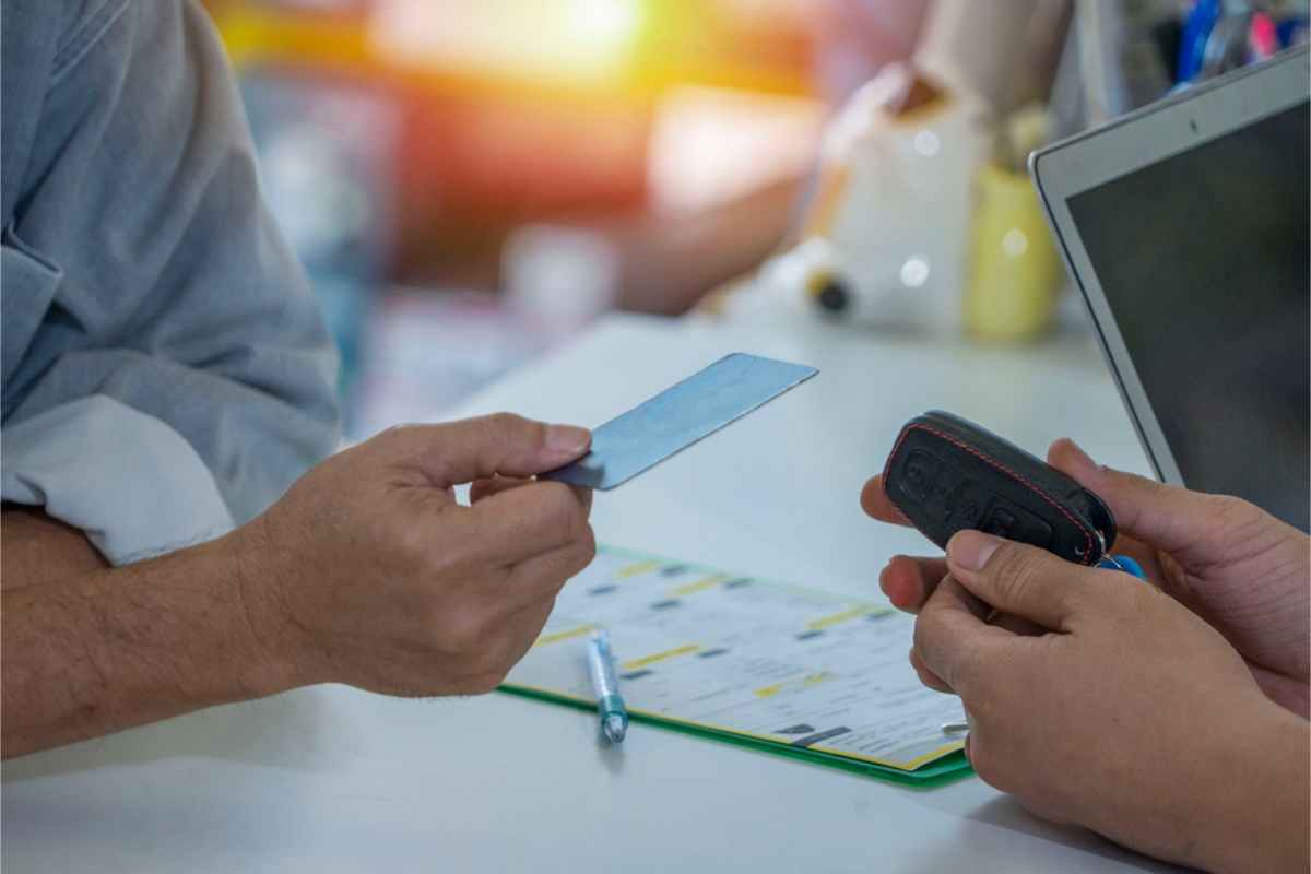 Renter paying his car rental deposit at the office with a credit card