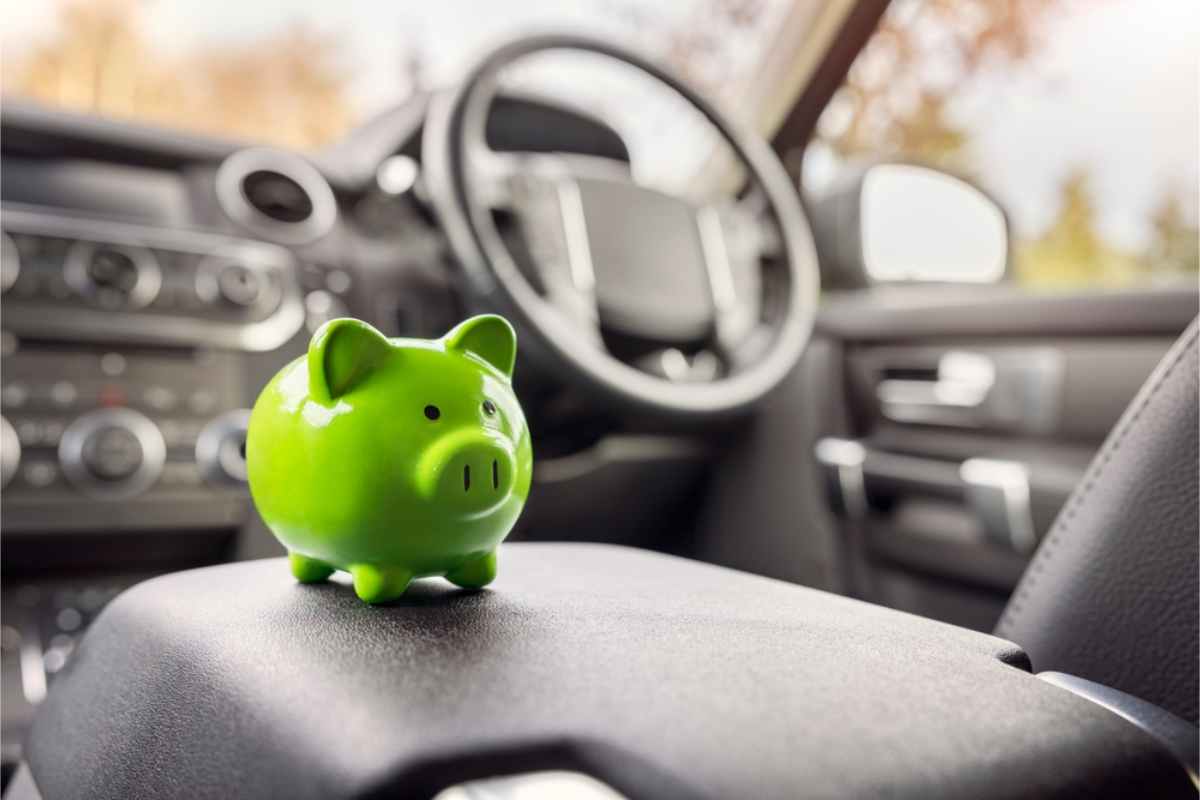 Green piggy bank inside a car evoking savings when renting a car