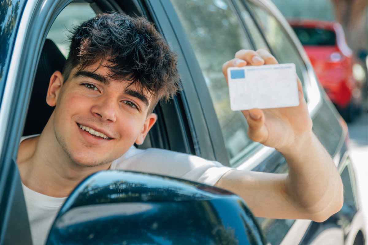 Young driver holding his driving permit while renting a car in Iceland