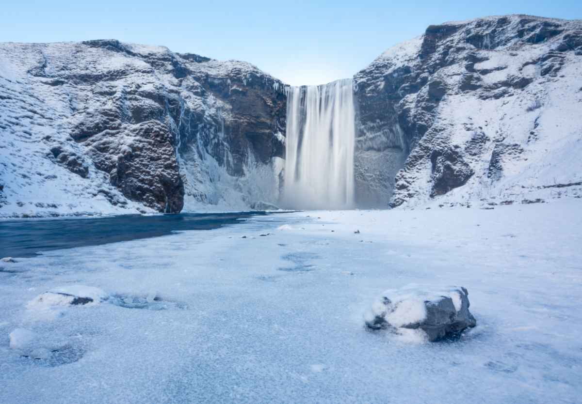 Skógafoss Waterfall completely frozen and covered in snow