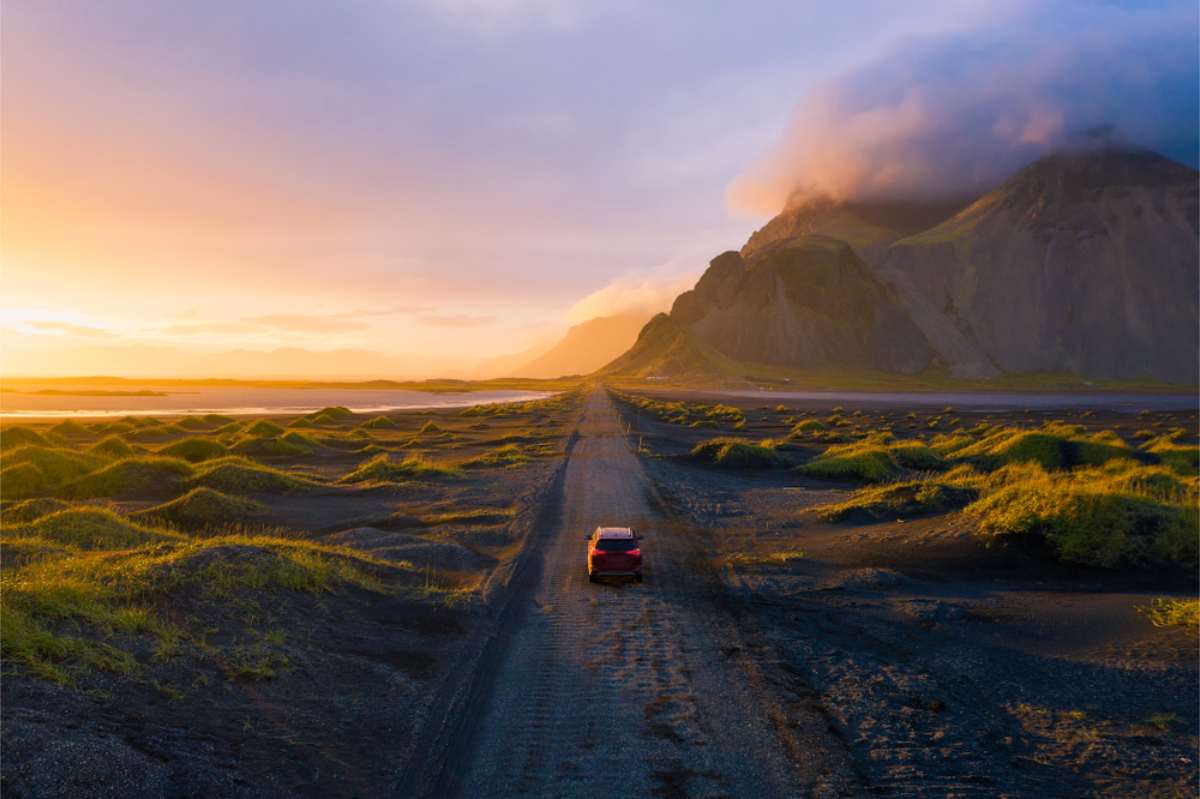 Car in Iceland rolling into the sunset