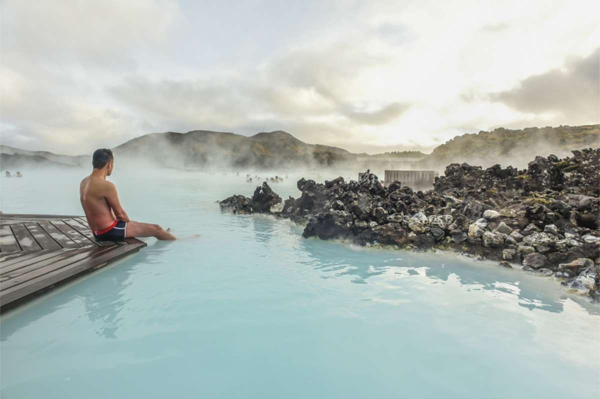 Tourist enjoying the blue waters of the Blue Lagoon in Iceland