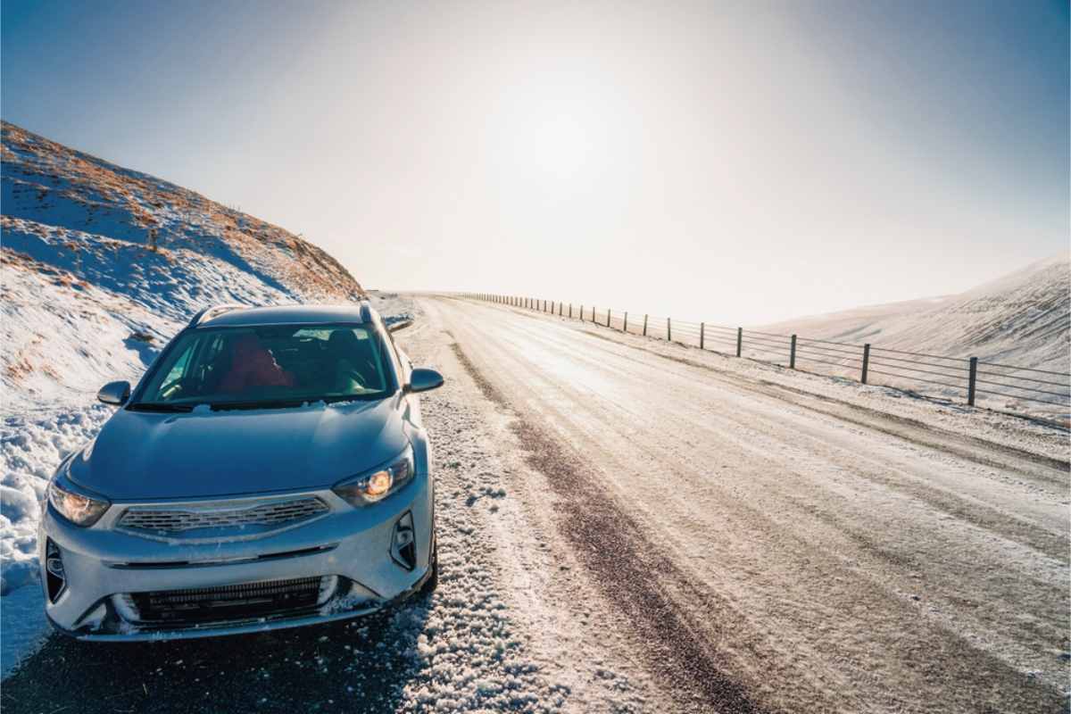 Weather conditions in Iceland in January Rental car parked by the road, which is covered in snow.