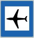 Road sign for airport nearby
