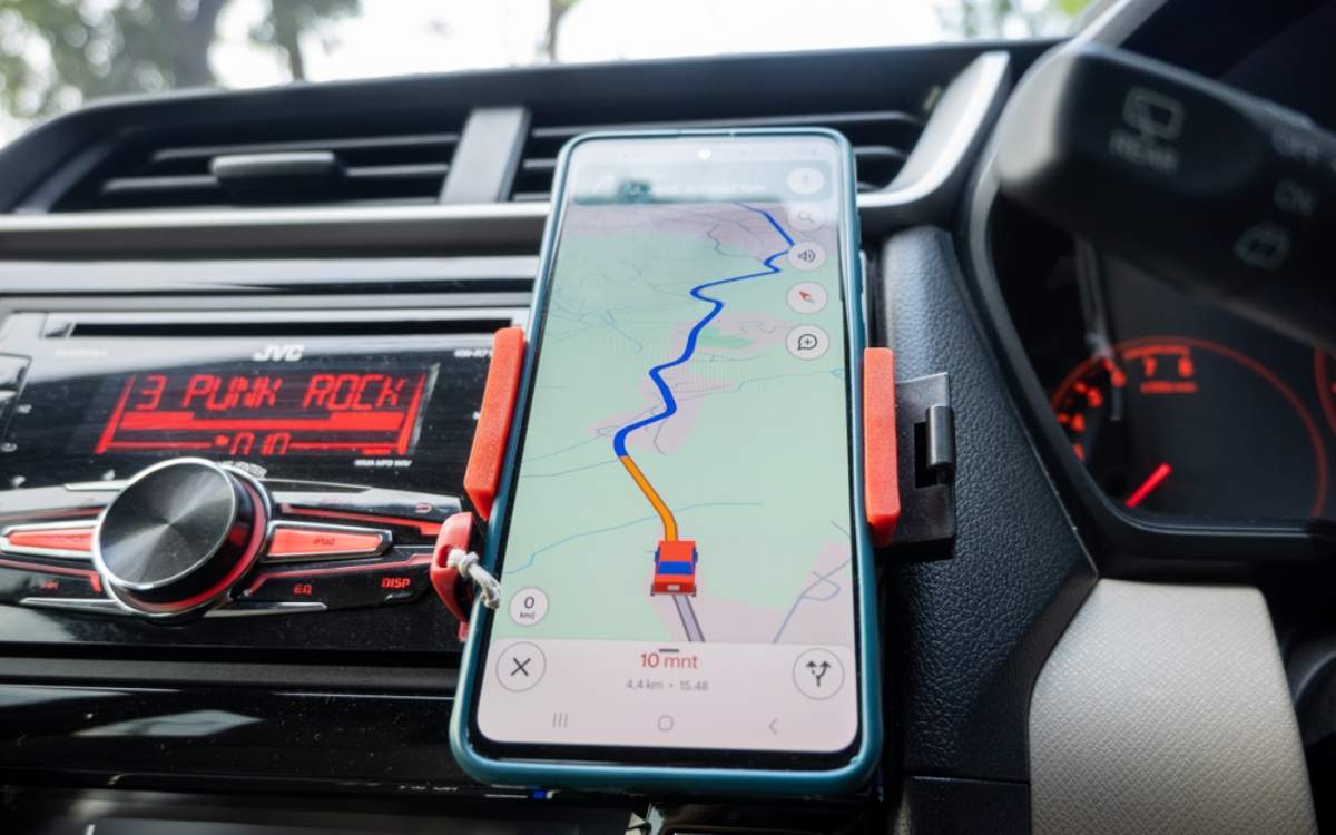 Phone on a car dashboard with Google Maps navigation on