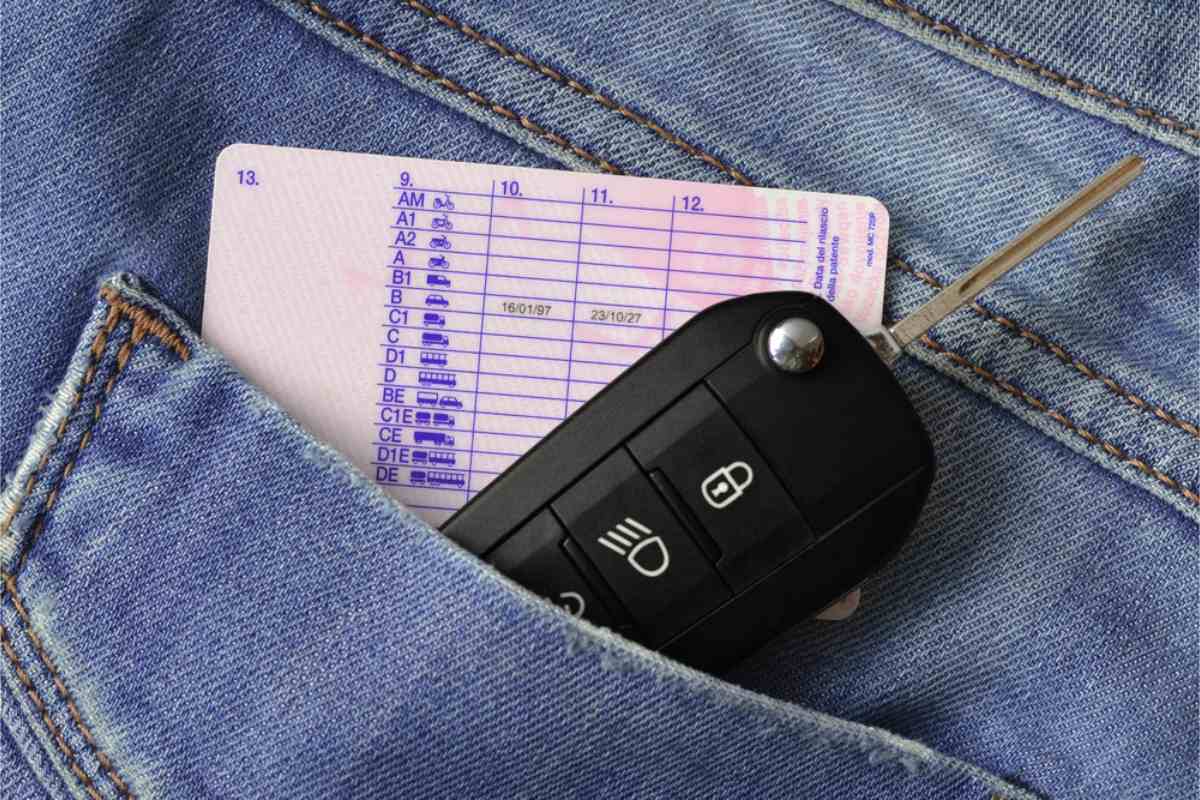 Car key and driver&rsquo;s license tucked into a jeans pocket, representing rental car requirements in Iceland
