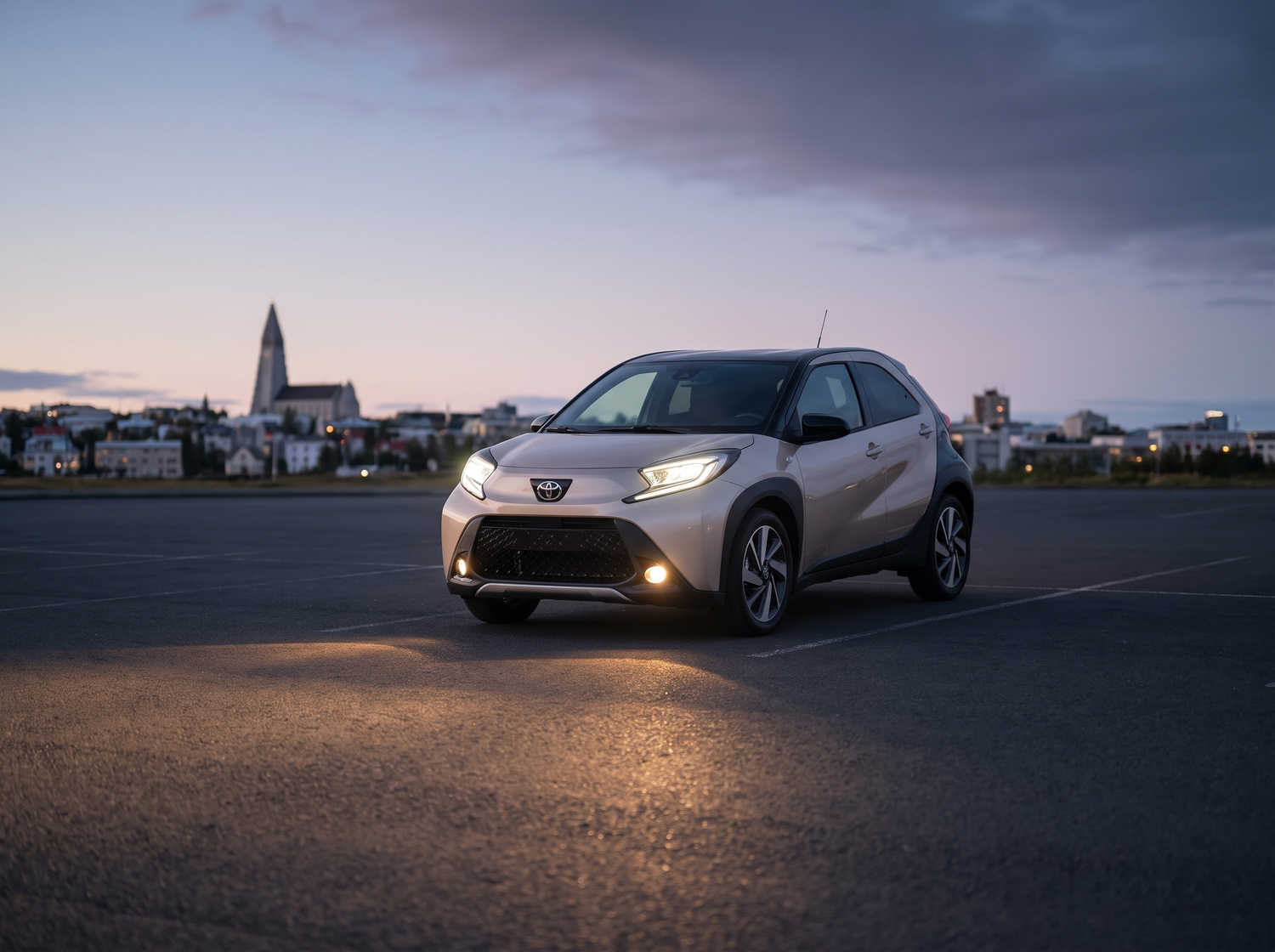 Vibrant orange Toyota Aygo with automatic transmission, ideal for 4 passengers, compact and efficient for Icelandic city travel.