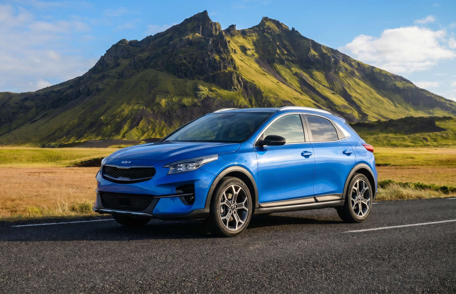 Bright yellow Kia XCeed automatic crossover with GPS, reverse camera, and heated seats, seats 5 with space for 2 luggage, ideal for Iceland trips.