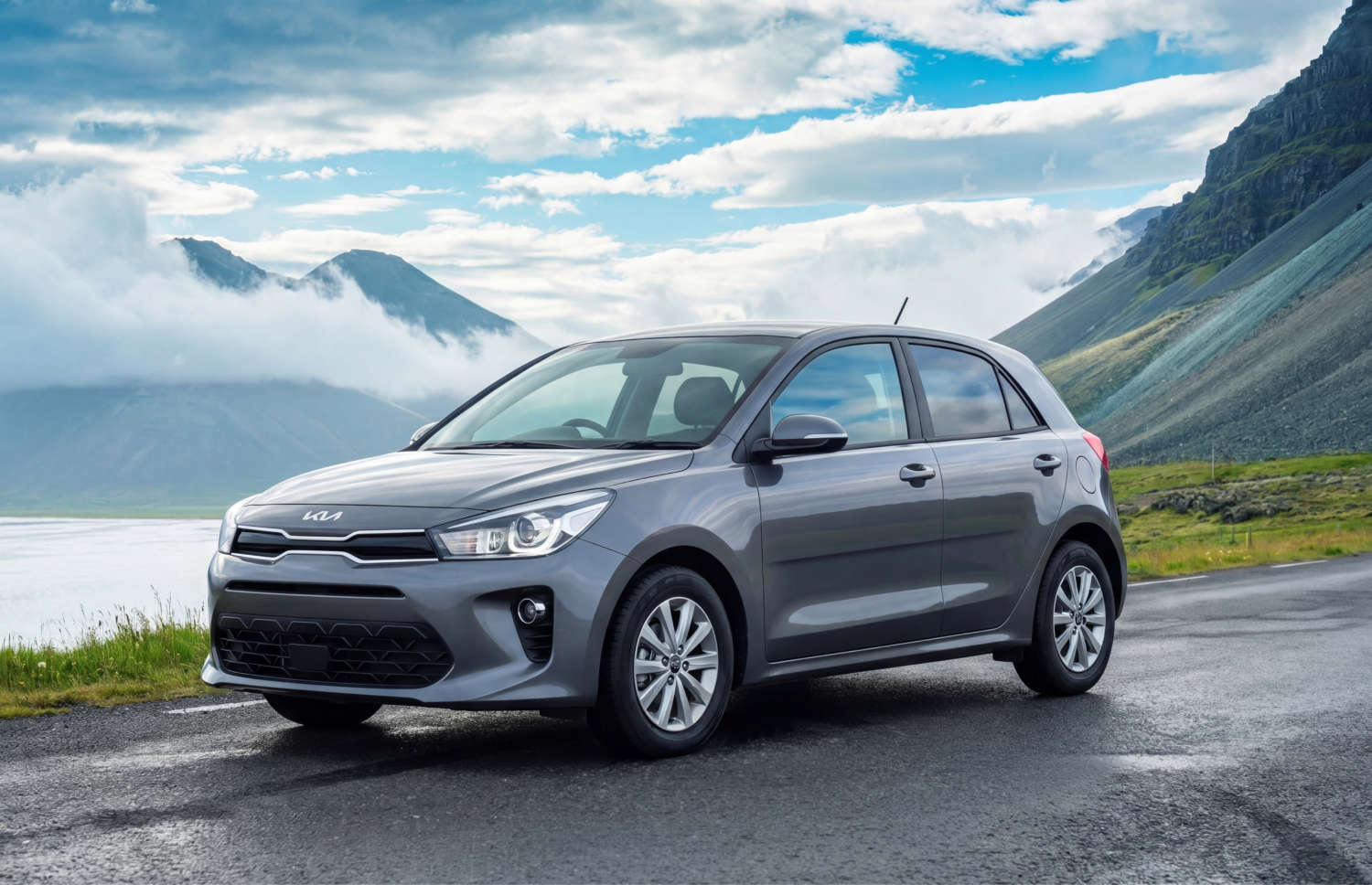 Blue Kia Rio with manual transmission, GPS, reverse camera, and space for 5 passengers and 2 luggage, ideal for Iceland road trips.
