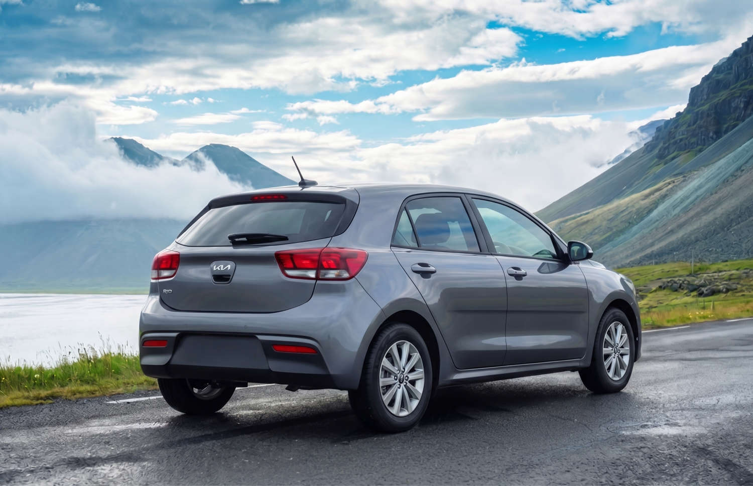 Blue Kia Rio with manual transmission, GPS, reverse camera, and space for 5 passengers and 2 luggage, ideal for Iceland road trips.