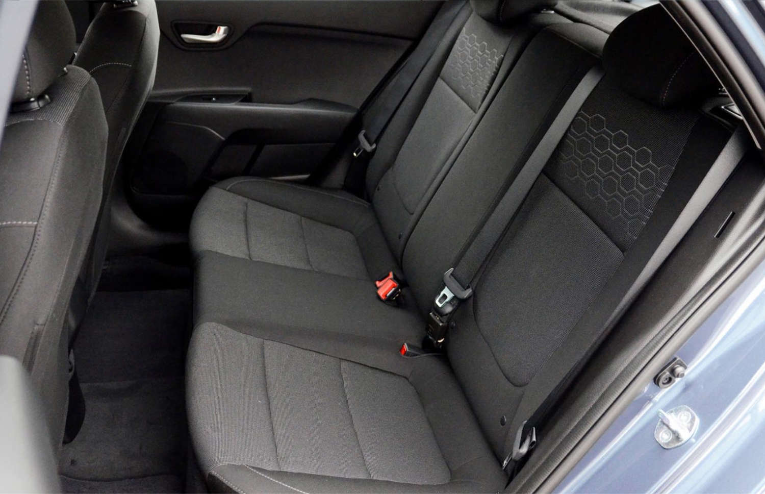 Blue Kia Rio with manual transmission, GPS, reverse camera, and space for 5 passengers and 2 luggage, ideal for Iceland road trips.