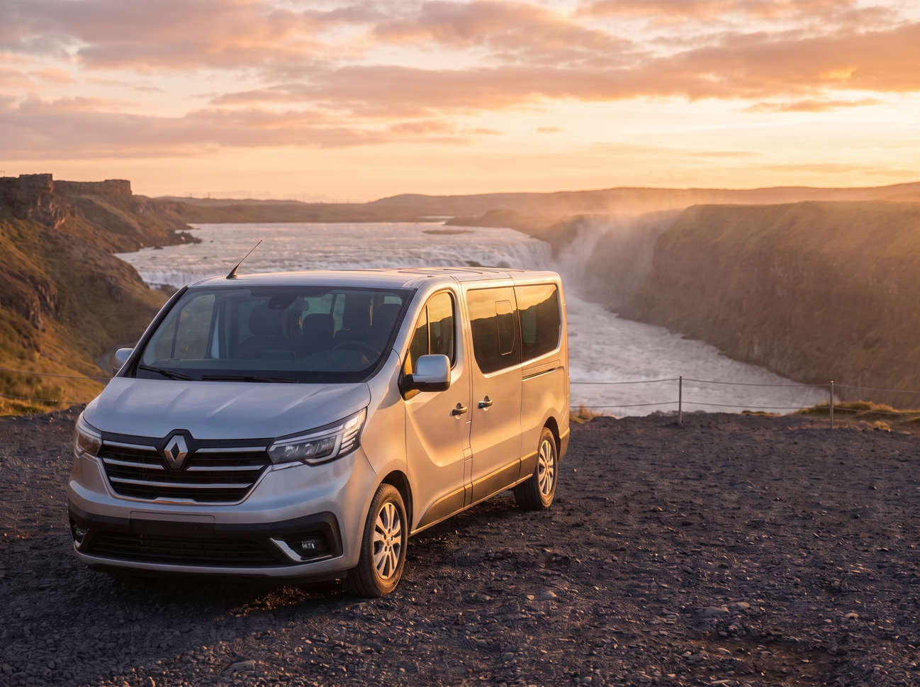 Red Renault Trafic 9-seater passenger van with manual transmission, heated seats, Bluetooth, and USB charger, ideal for group travel in Iceland.
