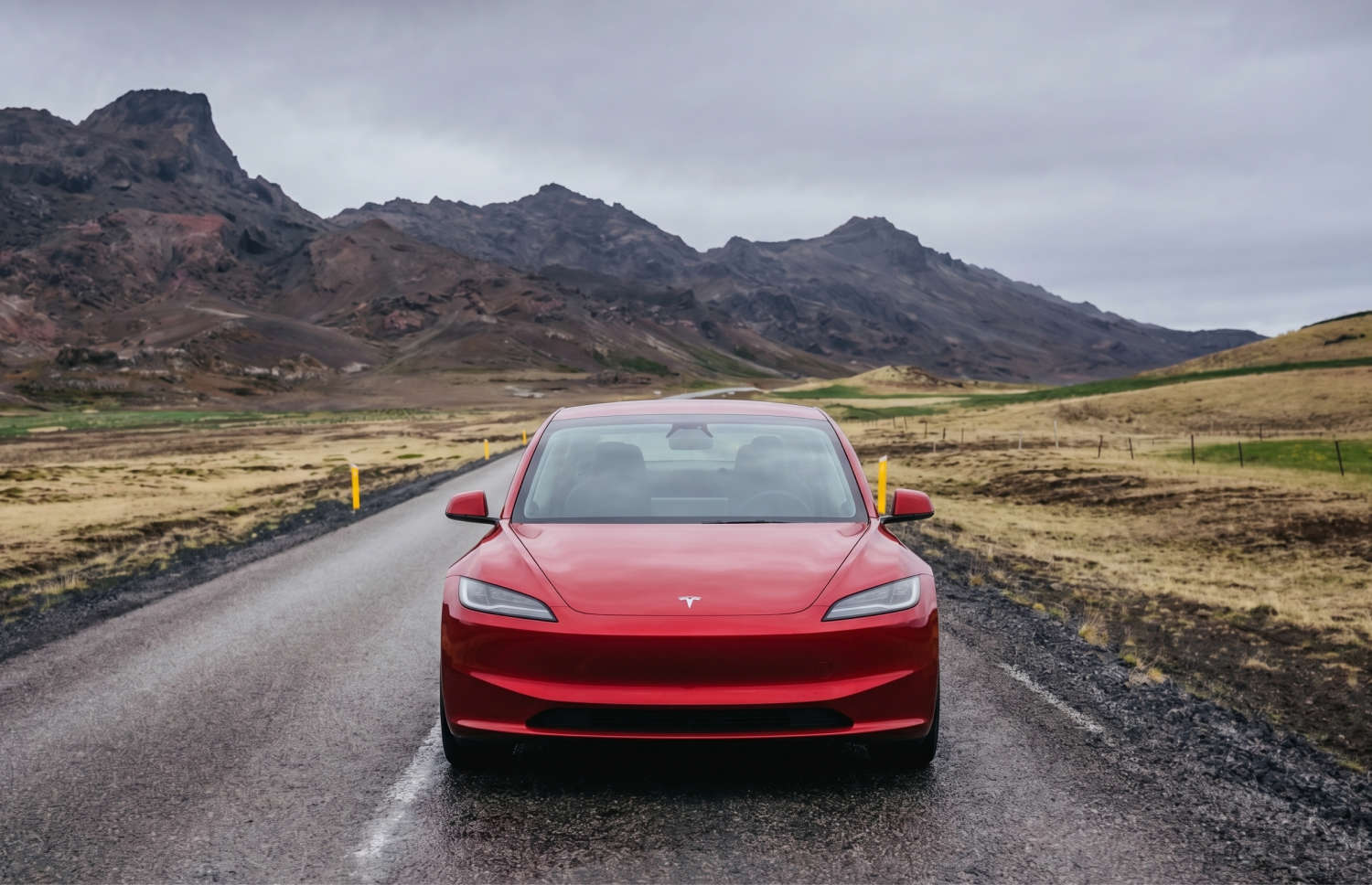 White Tesla Model 3 electric sedan with automatic transmission, GPS, reverse camera, heated seats, and space for 5 passengers in Iceland.