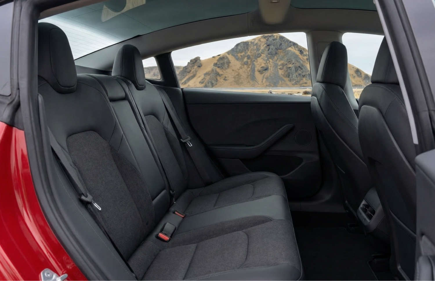 White Tesla Model 3 electric sedan with automatic transmission, GPS, reverse camera, heated seats, and space for 5 passengers in Iceland.