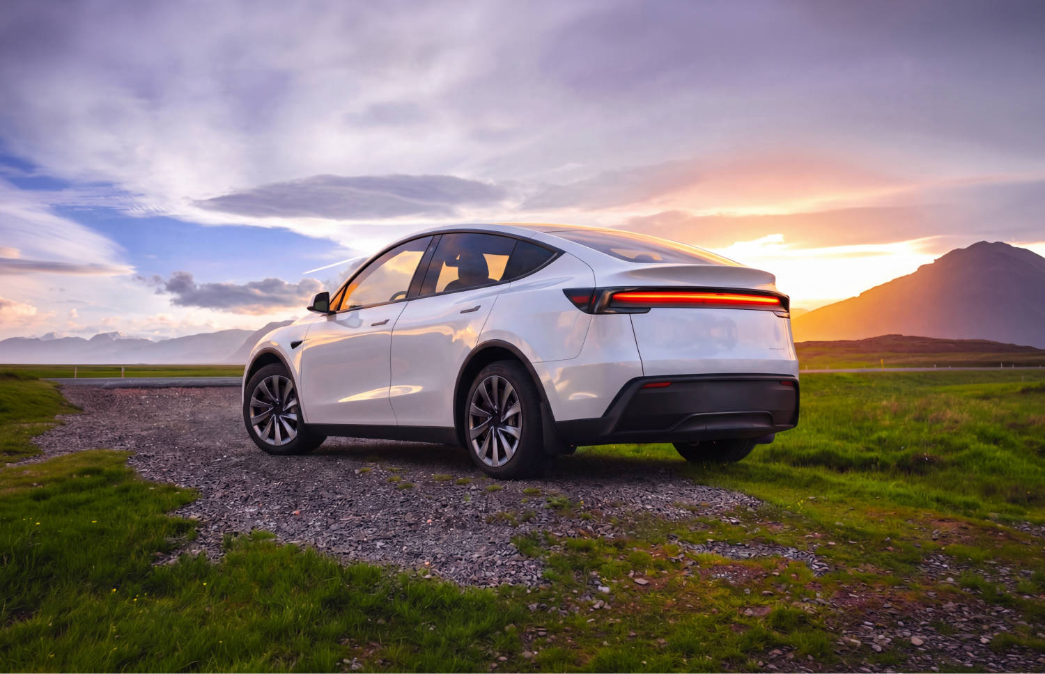 Blue Tesla Model Y electric SUV with automatic transmission, GPS, reverse camera, heated seats, and room for 5 passengers and 2 luggage in Iceland.