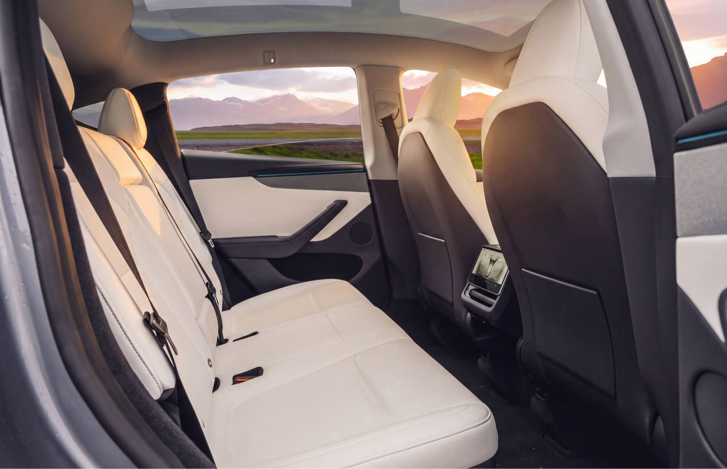 Blue Tesla Model Y electric SUV with automatic transmission, GPS, reverse camera, heated seats, and room for 5 passengers and 2 luggage in Iceland.