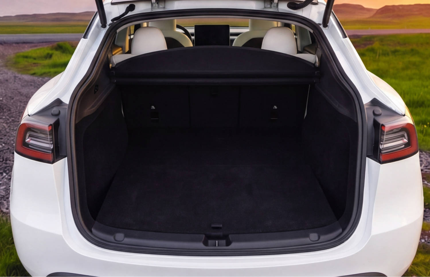 Blue Tesla Model Y electric SUV with automatic transmission, GPS, reverse camera, heated seats, and room for 5 passengers and 2 luggage in Iceland.