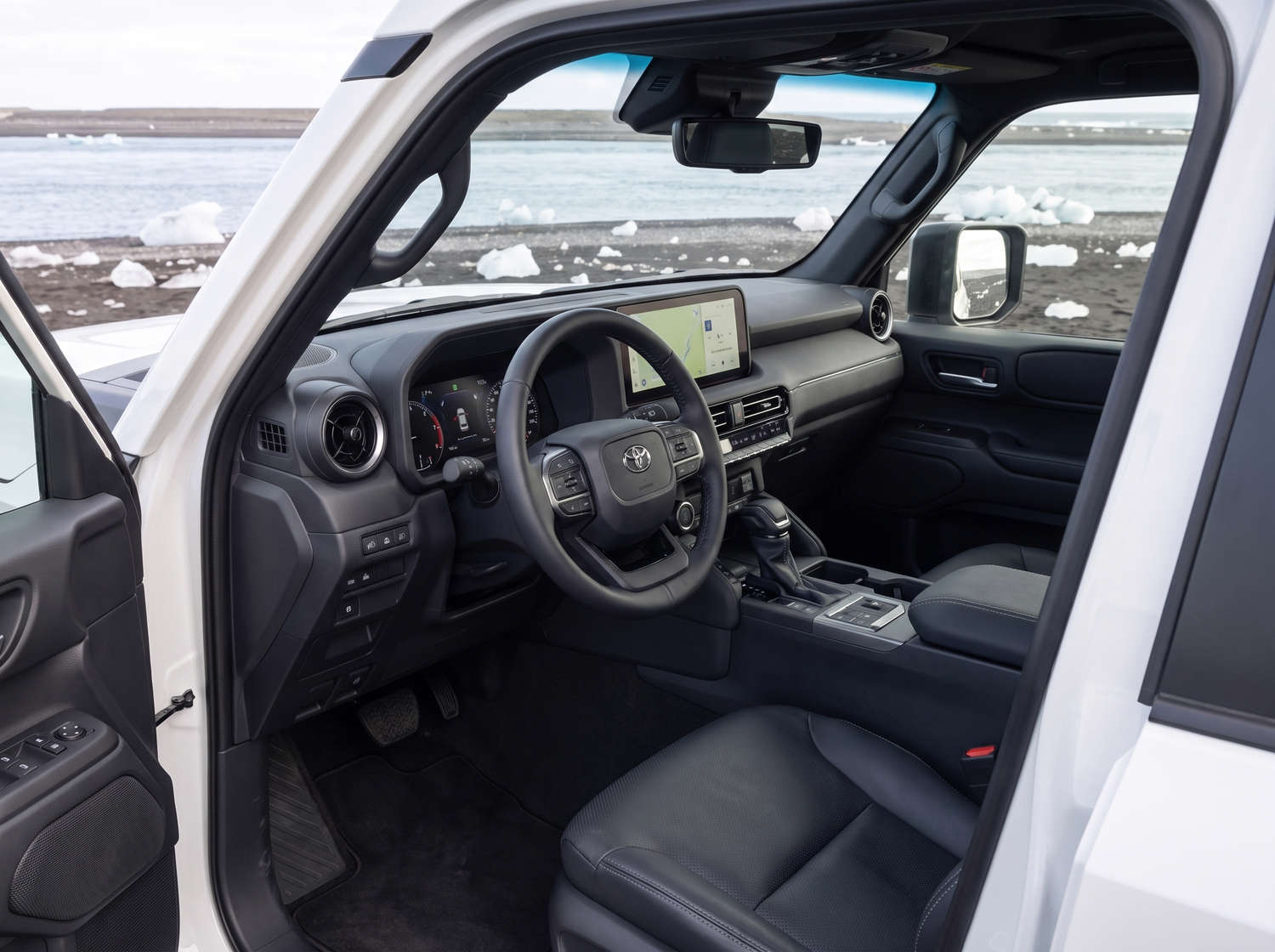 White Toyota Land Cruiser 250 4WD SUV with automatic transmission, 7 seats, USB charger, Bluetooth, and heated seats, perfect for Iceland off-road adventures.