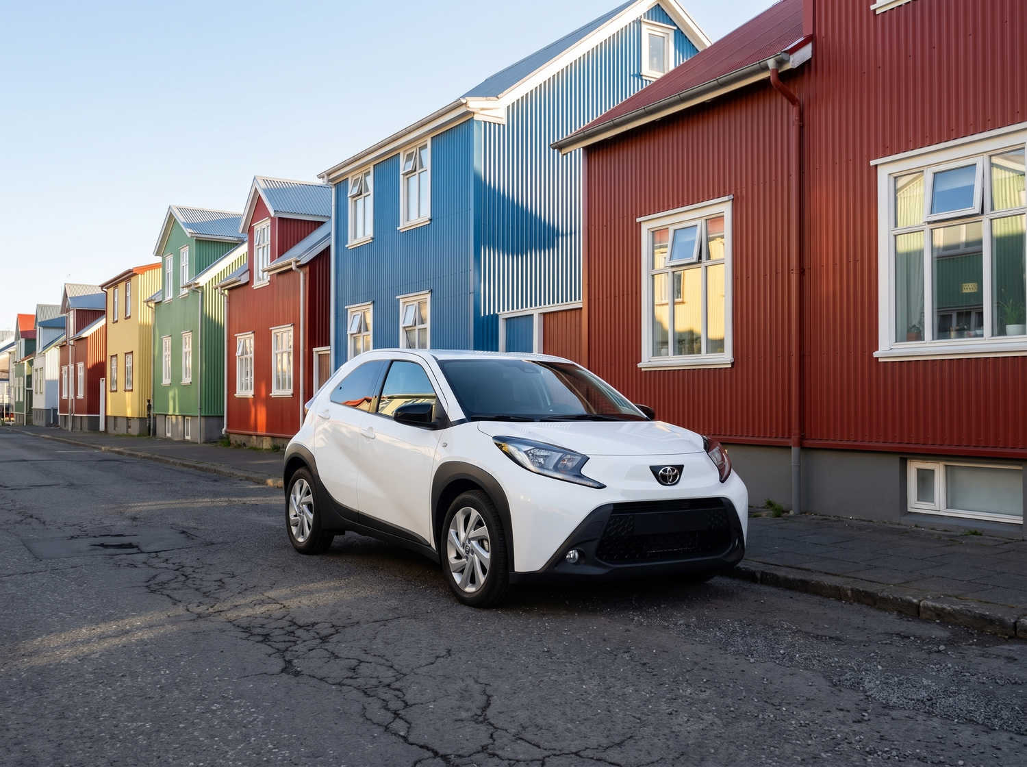 Compact Toyota Aygo in metallic grey with manual transmission, perfect for 4 passengers, ideal for city driving in Iceland.