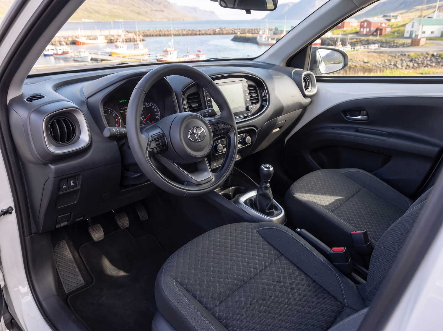 Compact Toyota Aygo in metallic grey with manual transmission, perfect for 4 passengers, ideal for city driving in Iceland.