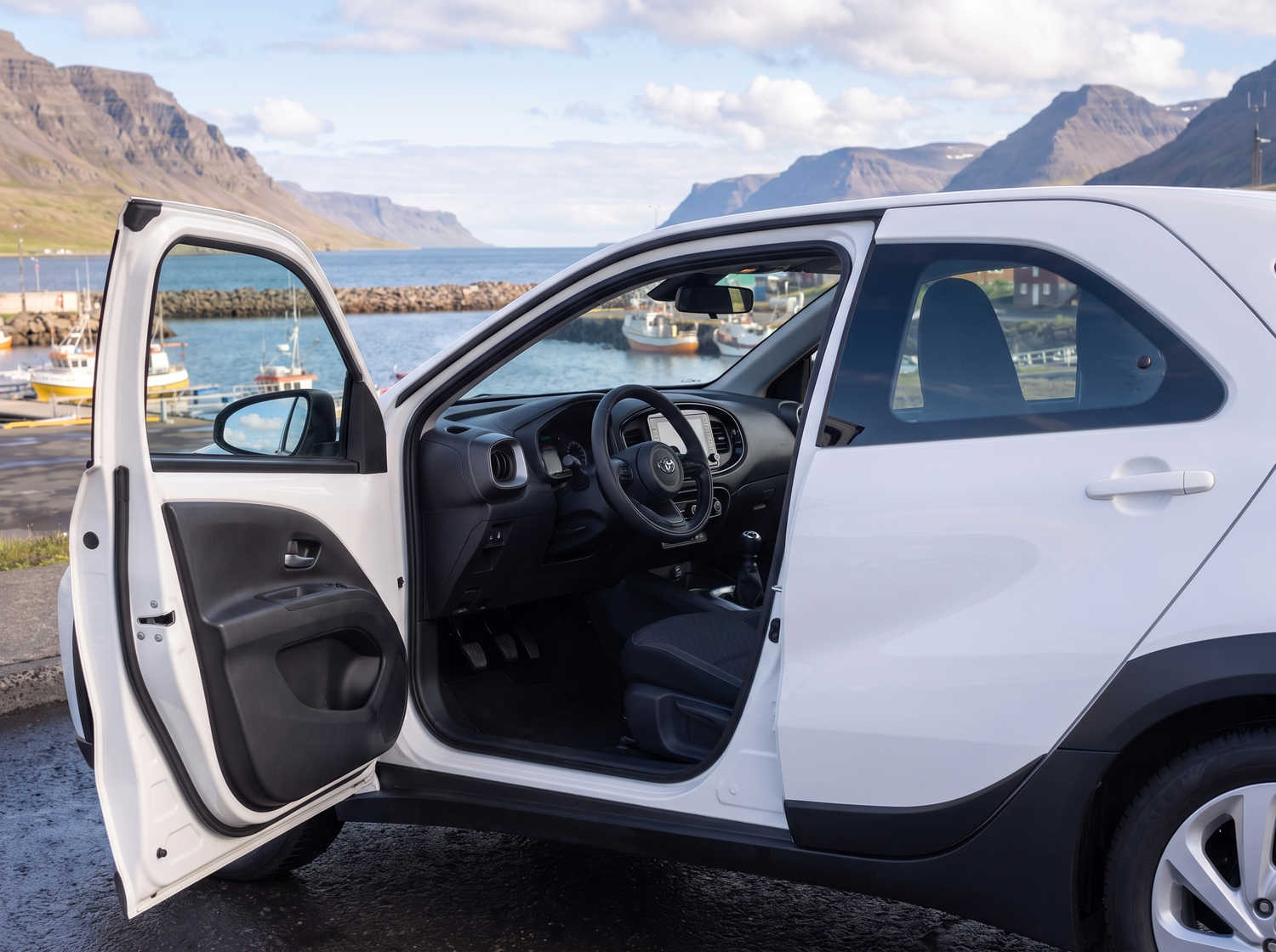 Compact Toyota Aygo in metallic grey with manual transmission, perfect for 4 passengers, ideal for city driving in Iceland.